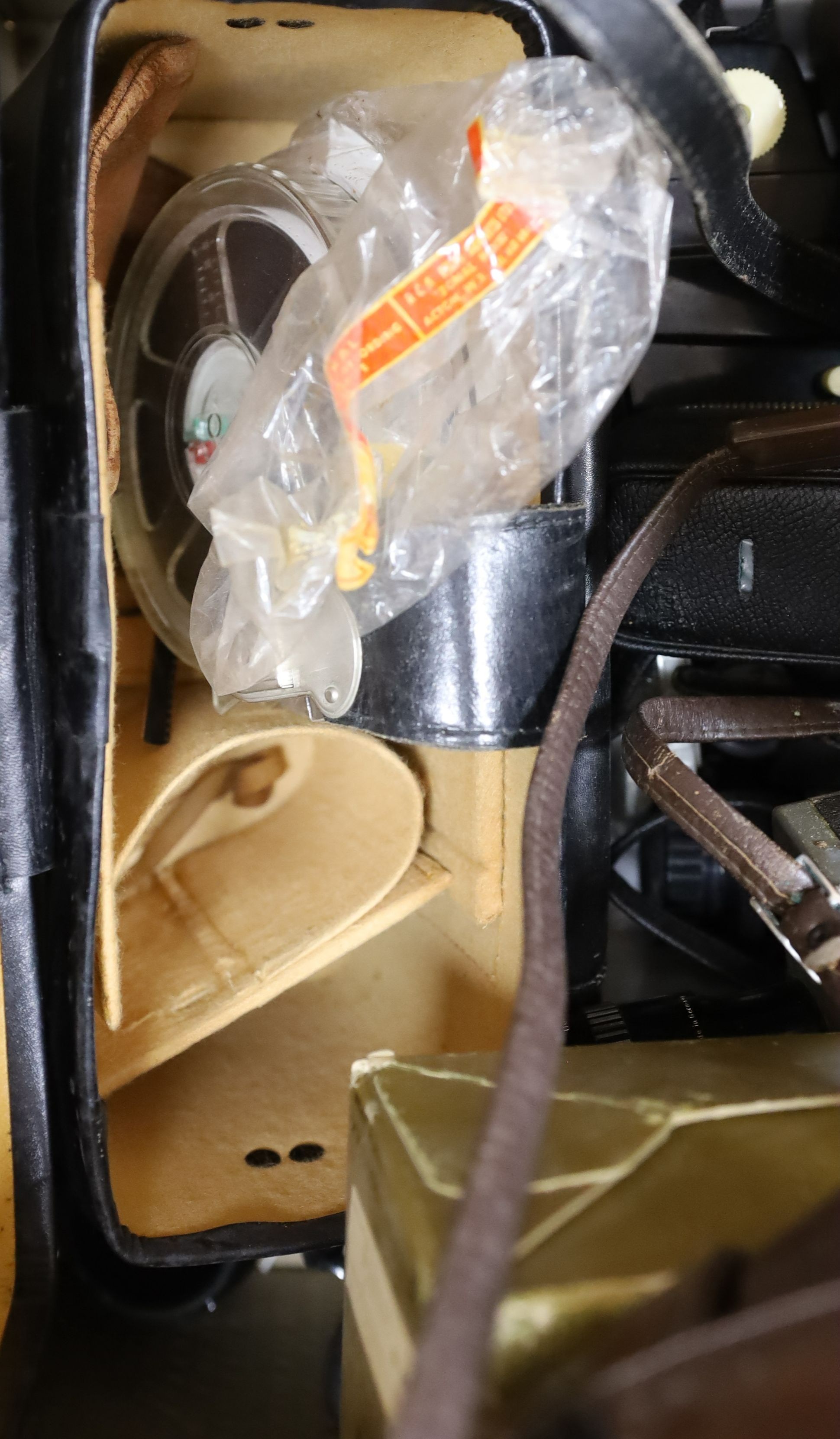 A Nikon Model F SLR camera, with additional telephoto lenses and other sundry cameras, etc.